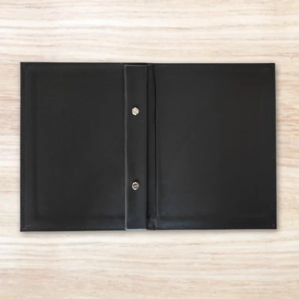 Black A5 Slim Leatherette Menu Cover On A Wooden Table. Made In South Africa By Signup Media In Durban